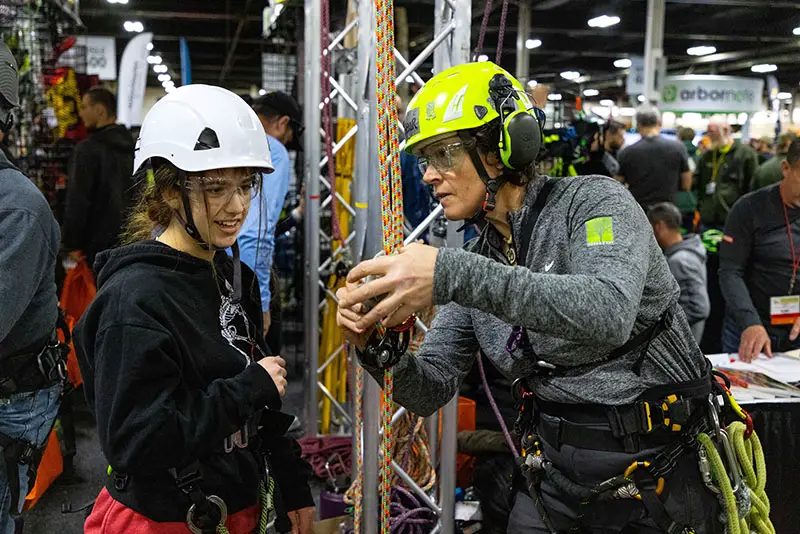 A student learns about climbing from an exhibitor.