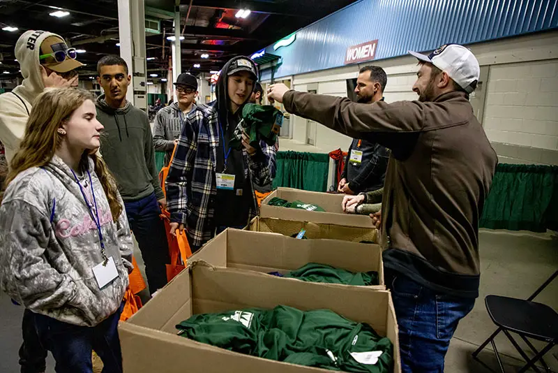 Students line up to receive free ArborEXPO shirts.