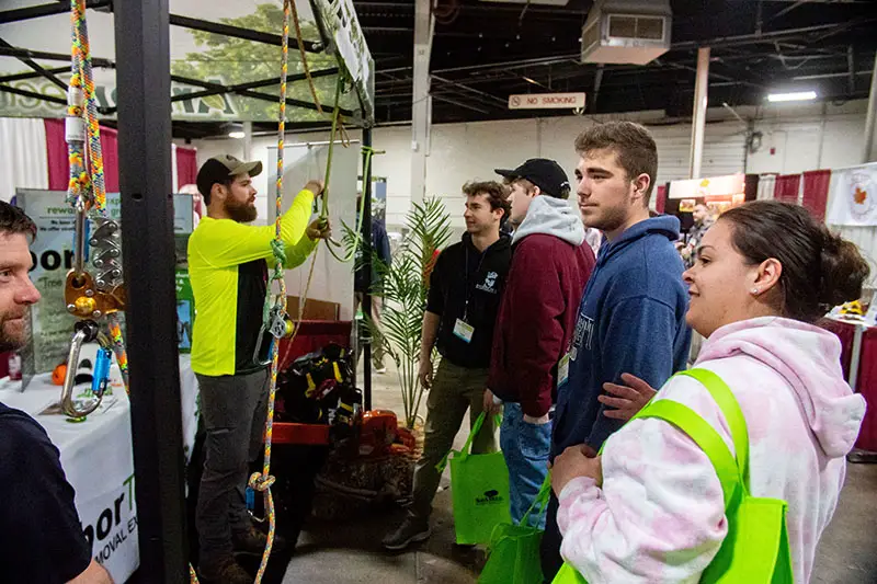 Students listening to an exhibitor during ArborEXPO.